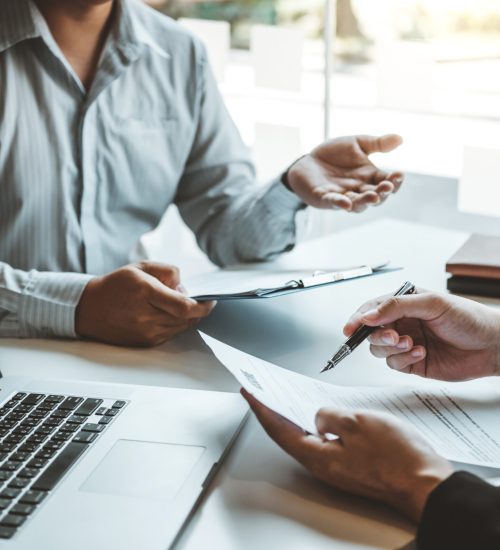 Senior manager HR reading a resume during a job interview employee young man meeting Applicant and recruitment